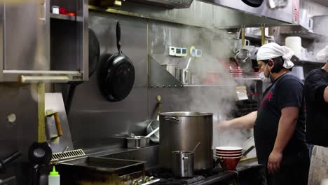 chef preparing food in a steamy kitchen