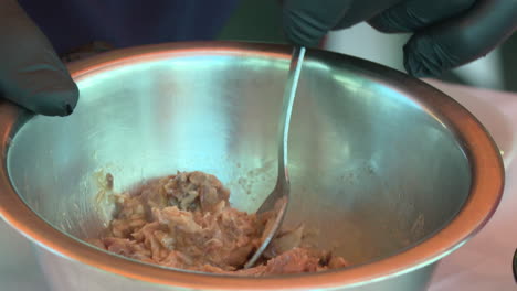 mixing tuna in a bowl