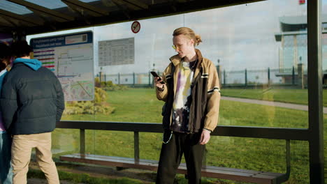 young man at bus stop