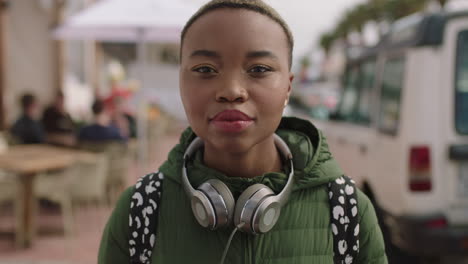 portrait of young beautiful african american woman looking serious wearing headphones