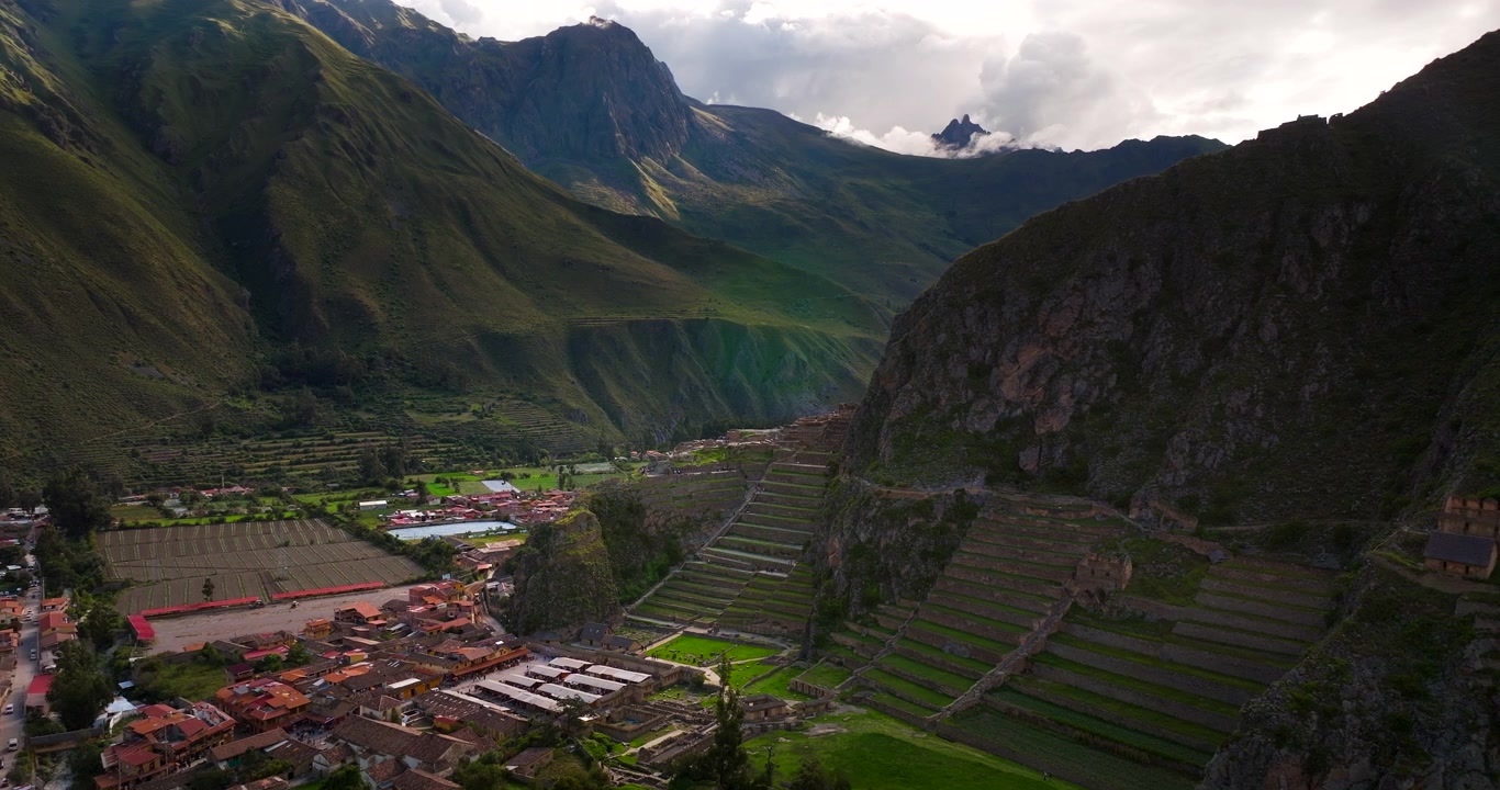 Veduta aerea della moderna città di Ollantaytambo con i suoi tetti rossi accanto all'antica fortezza e alle terrazze Inca nella Valle Sacra, Perù