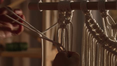 close-up of macrame wall hanging being made