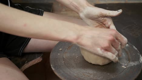 young woman makes a jug of clay. female hands mold pottery