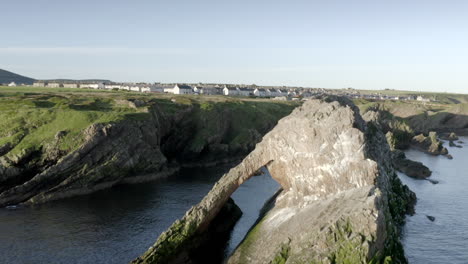 an aerial view of bow fiddle rock at portknockie on a calm summer's morning