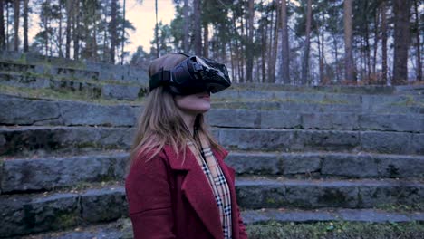 woman wearing vr headset in a park amphitheater