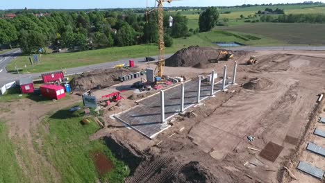 a drone flies over a large construction site on which a huge production hall is being built