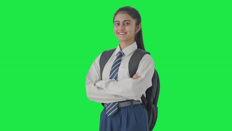 Portrait-of-Happy-Indian-school-girl-standing-crossed-hands-Green-screen