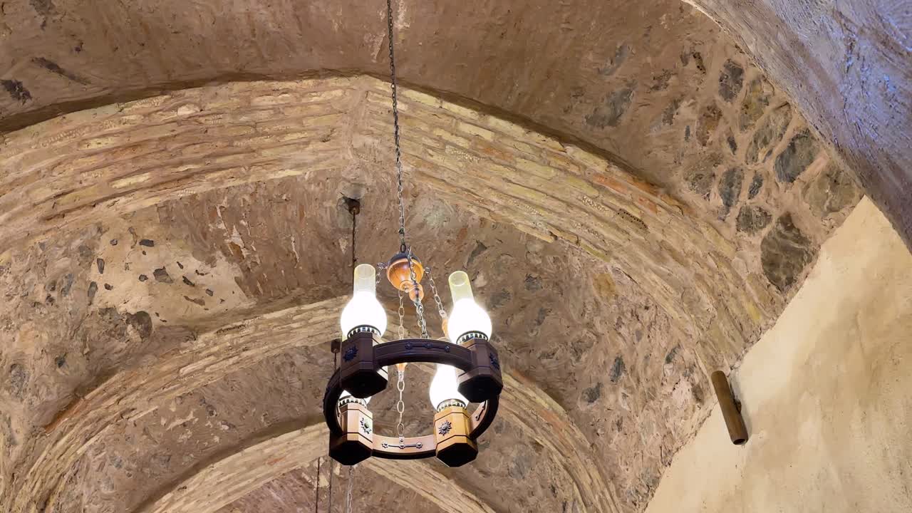 Chandelier in restaurant desert architectural design in Iran Persian Arabian culture of local ancient brick dome ceiling landmark historic interior decoration and vaulted roof religious vintage temple