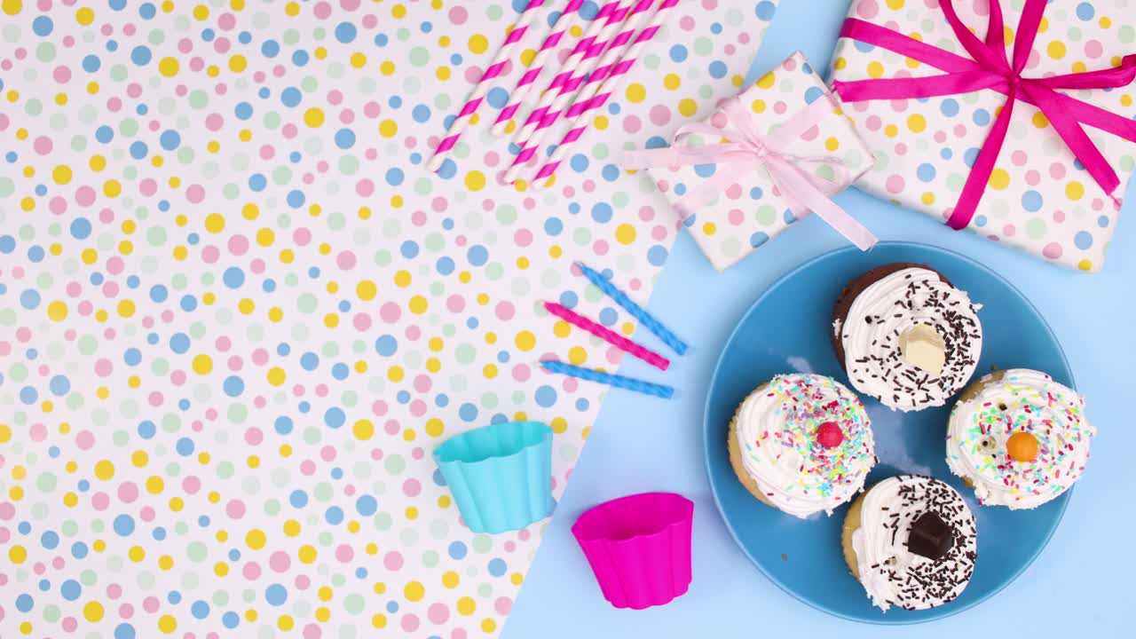 Birthday party decoration with cup cakes and gifts move on left side. Stop motion