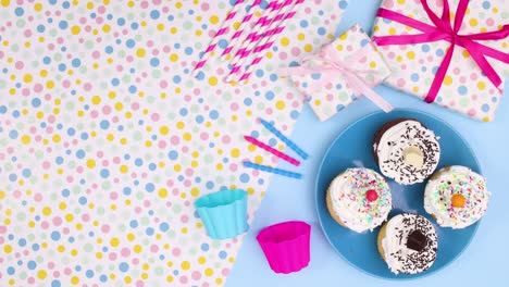 birthday party decoration with cup cakes and gifts move on left side. stop motion