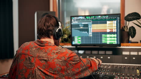 a man working in a music production studio