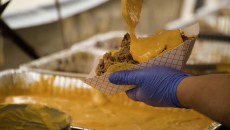 Vendor-Selling-BBQ-Cheese-Nachos-At-The-50th-Annual-Dogwood-Festival-In-Siloam-Springs,-AR,-USA---Close-Up,-Slow-Motion