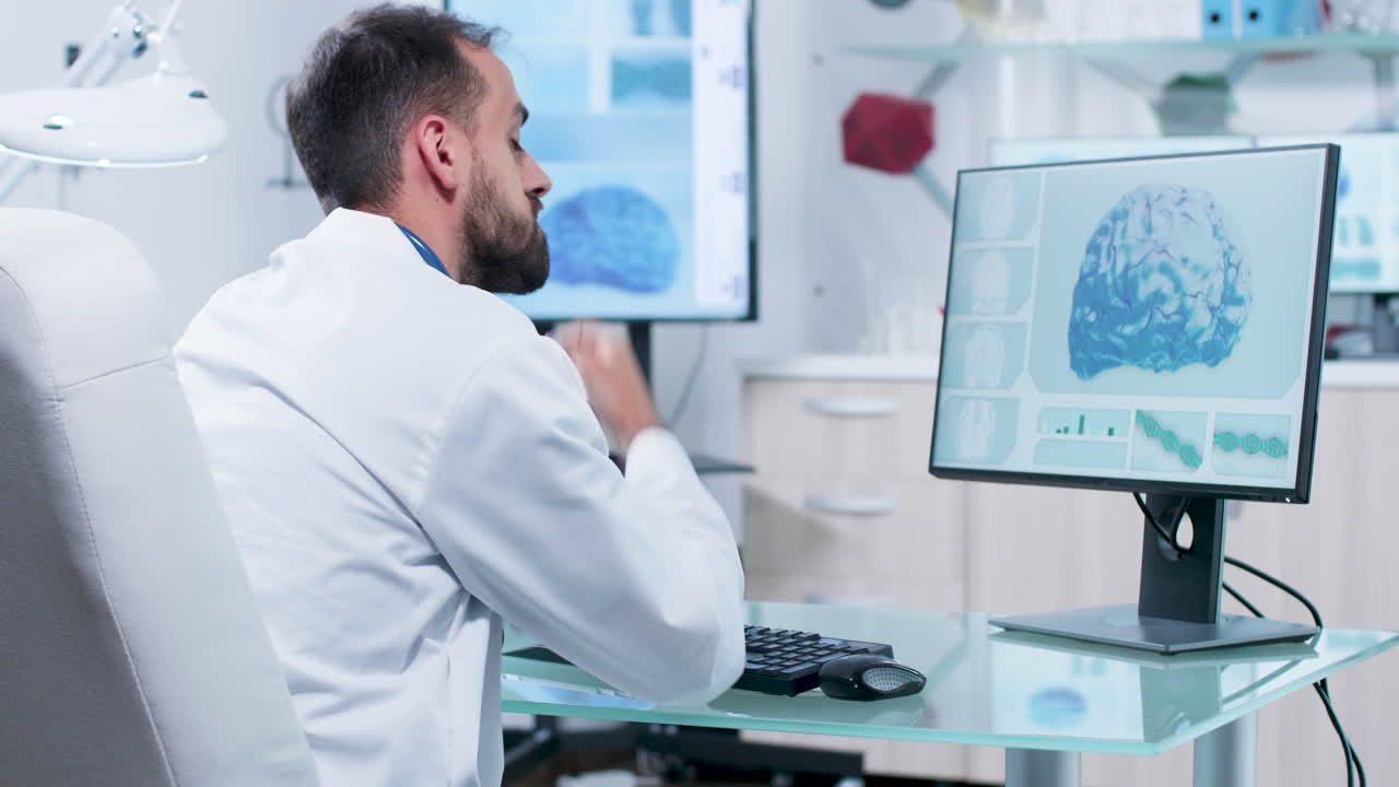 Doctor analyzing brain scan on computer