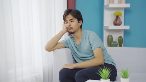 unhappy man listening to music with headphones.