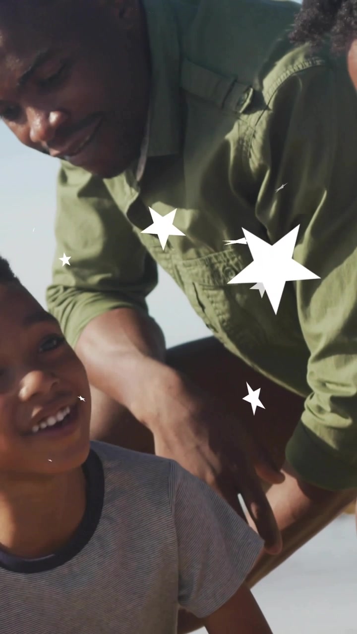Vertical video: Dad approaching, child digging sand looking up smiling as dad guiding, stars drift