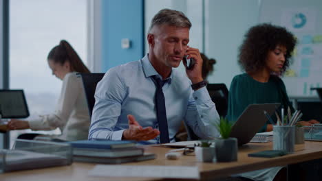 angry business man working on laptop in office