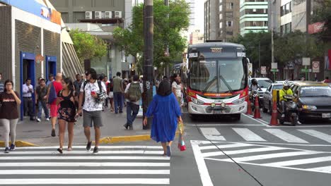 people and public transport on a busy city street in lima, peru