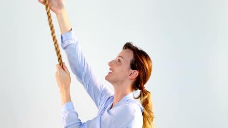 Woman-pulling-a-rope-against-white-background-4k