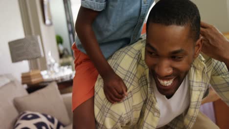 father giving a piggyback ride to his son 4k