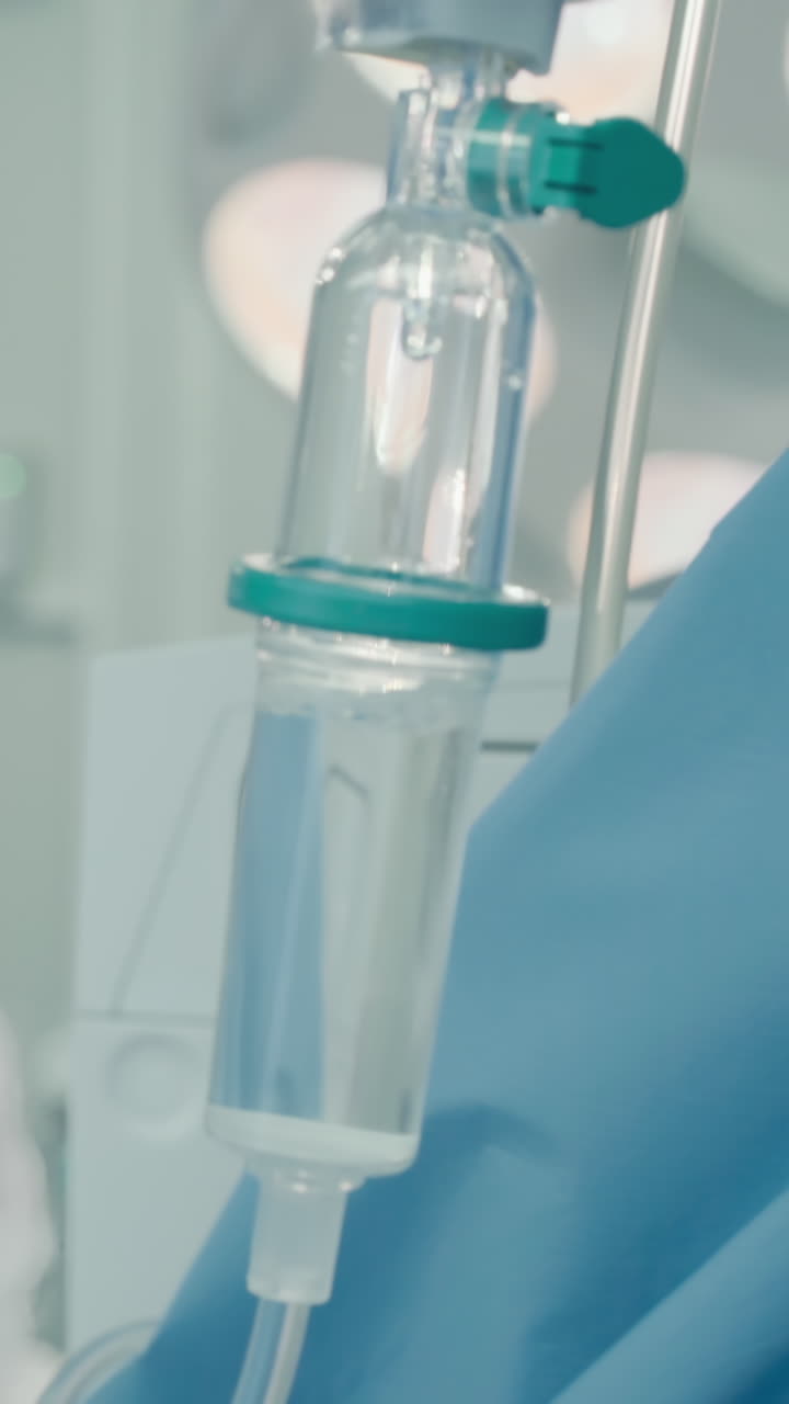 Doctor operates with assistant aid. I.V. against surgeon performing artery bypass surgery supported by nursing staff in hospital operating room