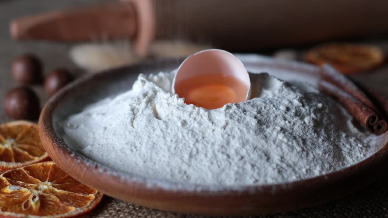 Food ingredients for homemade baking still life with white flour and egg yolk