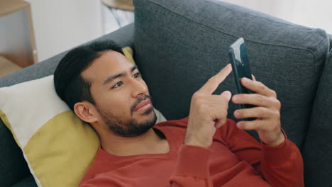 Sofa,-happy-and-relax-man-with-phone-scroll