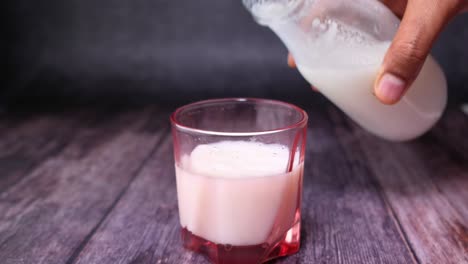 pouring milk into a glass