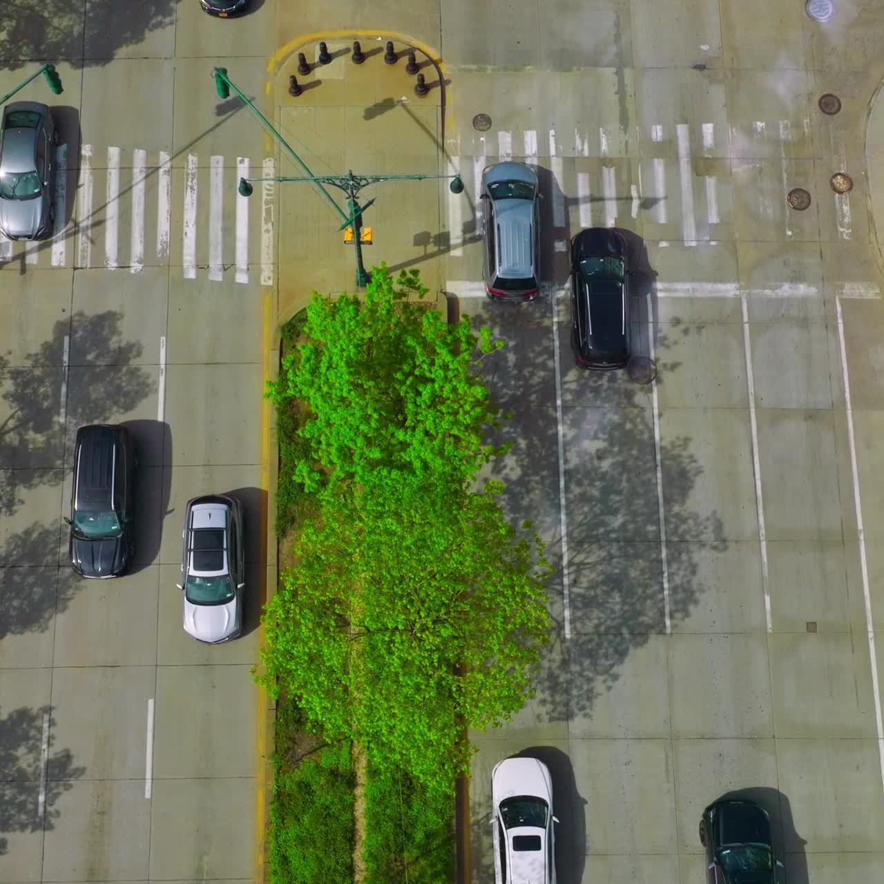 Traffic of a busy city at daytime. Automobiles moving quickly by the broad roads. View from top