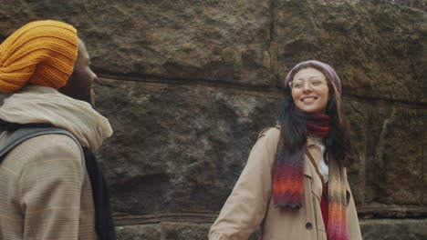 multiethnic couple having romantic walk in old town