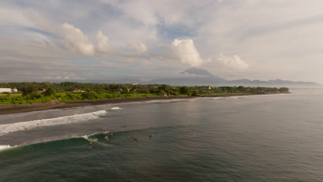 surfers waiting to catch waves at a beach in bali