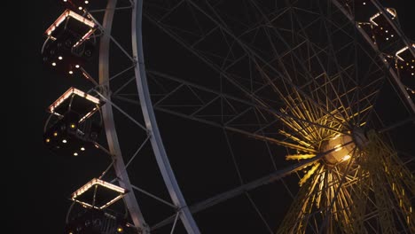 bright ferris wheel turning spinning at night at a amusement park