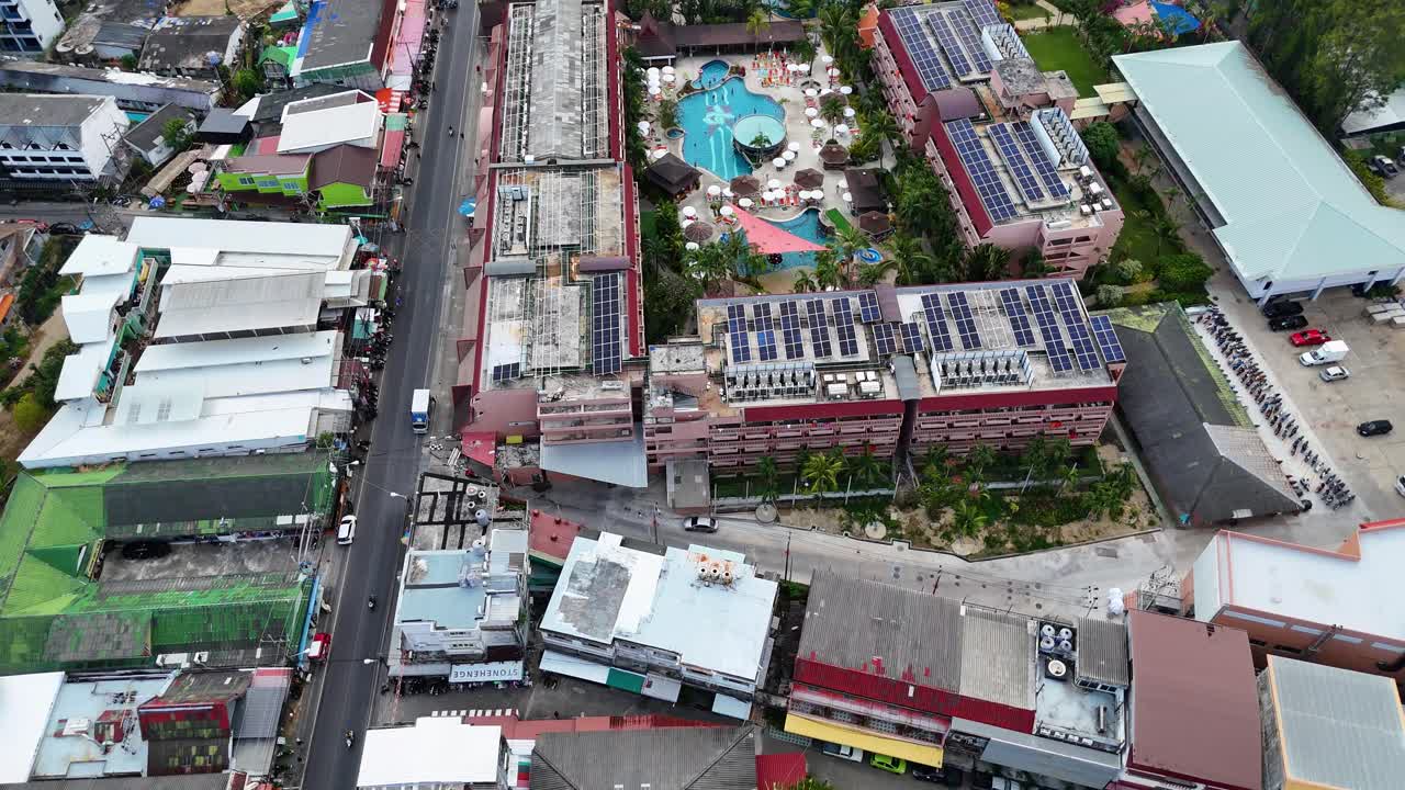 Drone footage captures vibrant Phuket streets and resort pools from above, showcasing urban and leisure environments in bright daylight