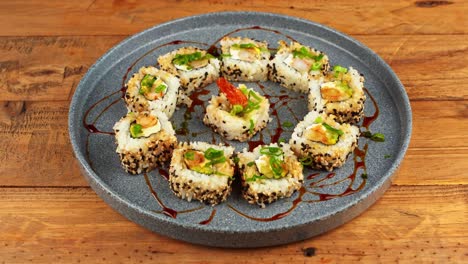 close up of a plate of california avocado sushi being removed from a wooden table in a restaurant