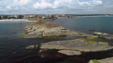 Drone-arc-footage-around-small-island-in-Black-sea,-Bulgaria