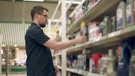 man shopping for cleaning products in a supermarket