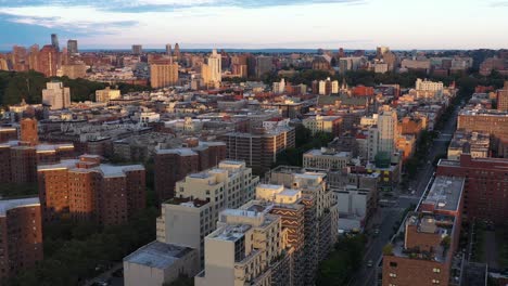 stationary aerial shot over the harlem neighborhood of nyc at sunrise golden hour