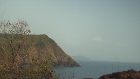 The-focus-changes-from-a-beautiful-cliff-overlooking-the-sea-to-an-old-ruin's-wall