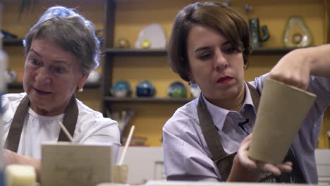 women learning pottery in a workshop