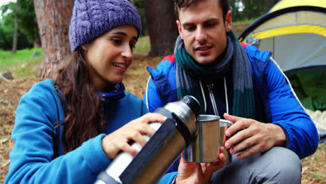 hiker woman serving coffee to her husband