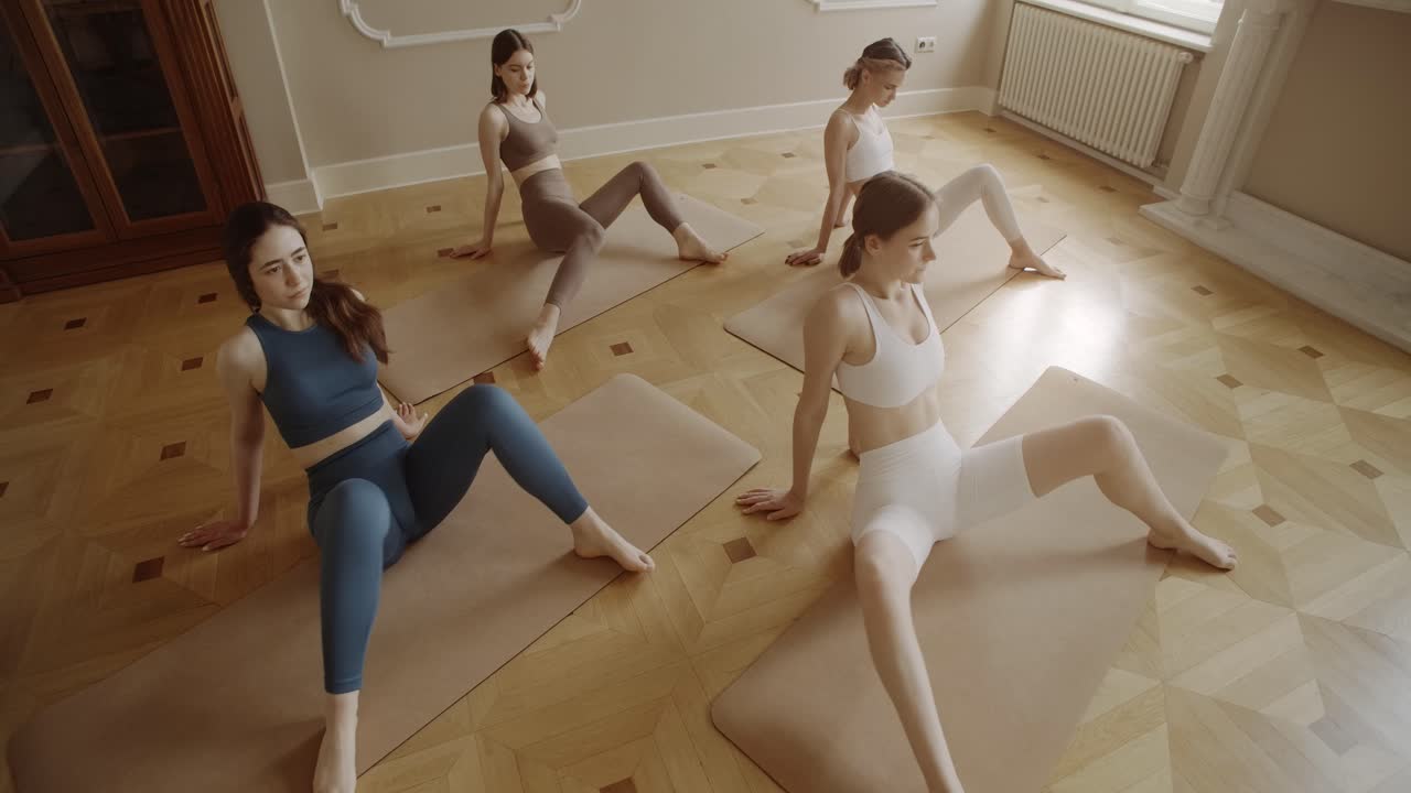 Women practicing yoga in studio