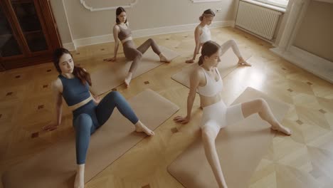 women practicing yoga in studio