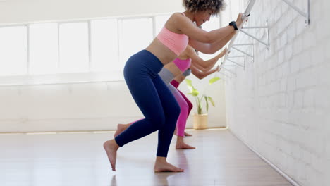 dos mujeres biraciales y una mujer caucásica están haciendo yoga