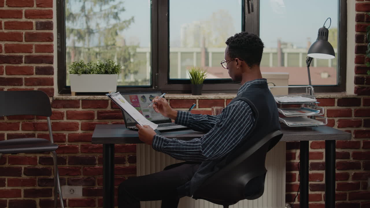 Financial consultant working on laptop with sales statistics