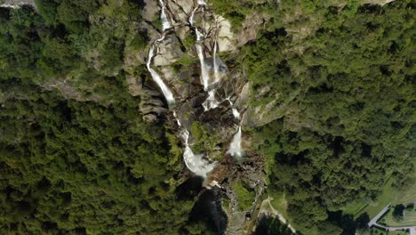 bird's eye view over acquafraggia waterfalls in sondrio, lombardy, north italy - drone shot