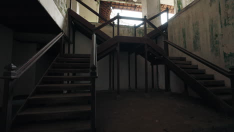 Abandoned Building Interior with Intersecting Wooden Staircases