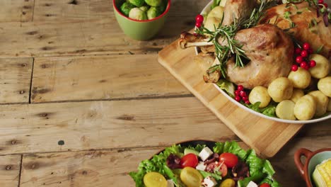 video of tray with roasted turkey, potatoes and vegetables on wooden surface