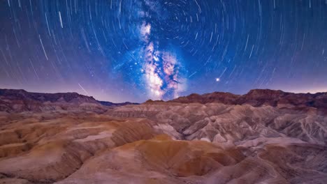 star trails and milky way over desert landscape