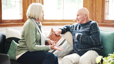 stress, fighting and senior couple on a sofa