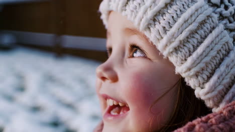 a little girl is surprised by the winter snow