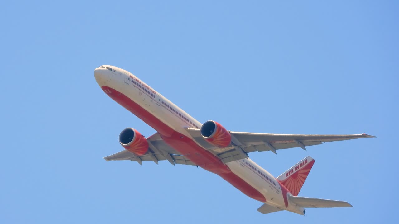 Plane takes off from Toronto International Airport, flies in blue sky during the day